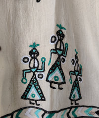 Embroidered design of people on a beige fabric 