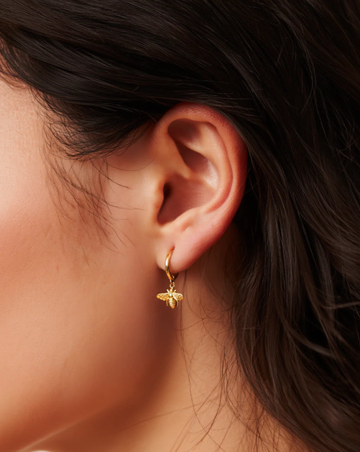Bumblebee Drop Huggies — recycled silver bee drop charm on huggie hoops, side view ethical jewelry