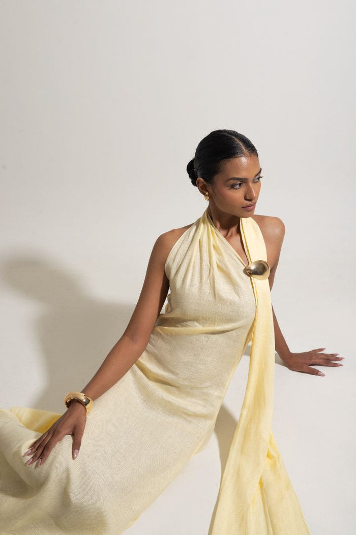 Woman wearing a light yellow halter neck dress 