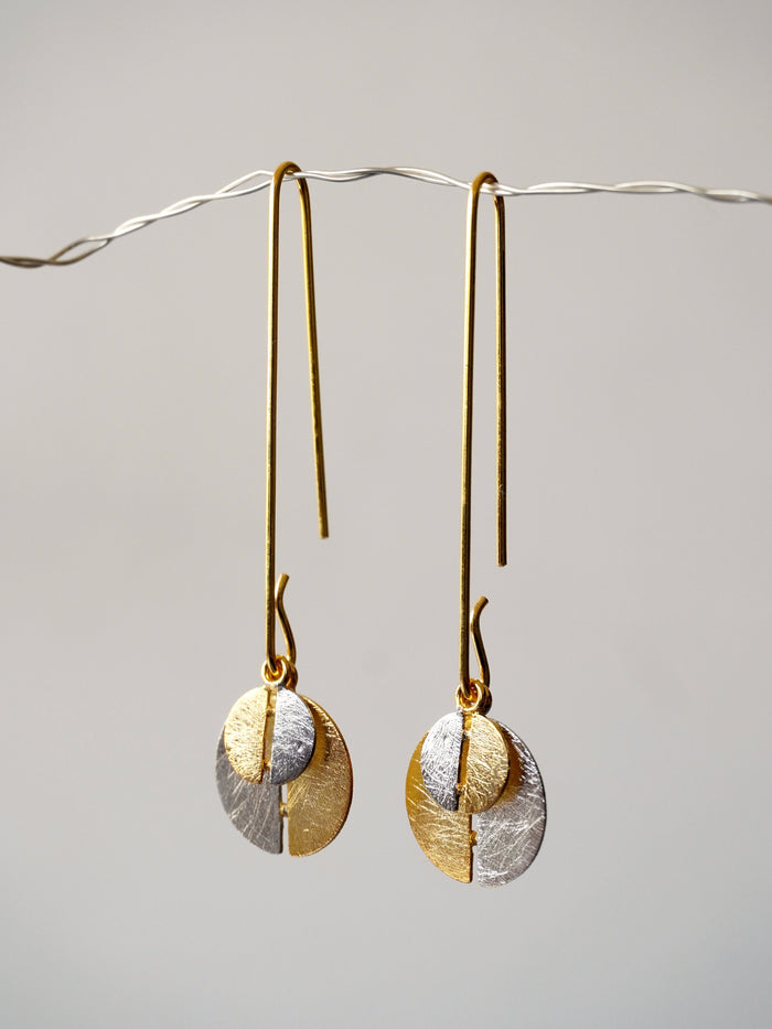Alto Yin Yang De'anma brass symbolic earrings worn model artisan India