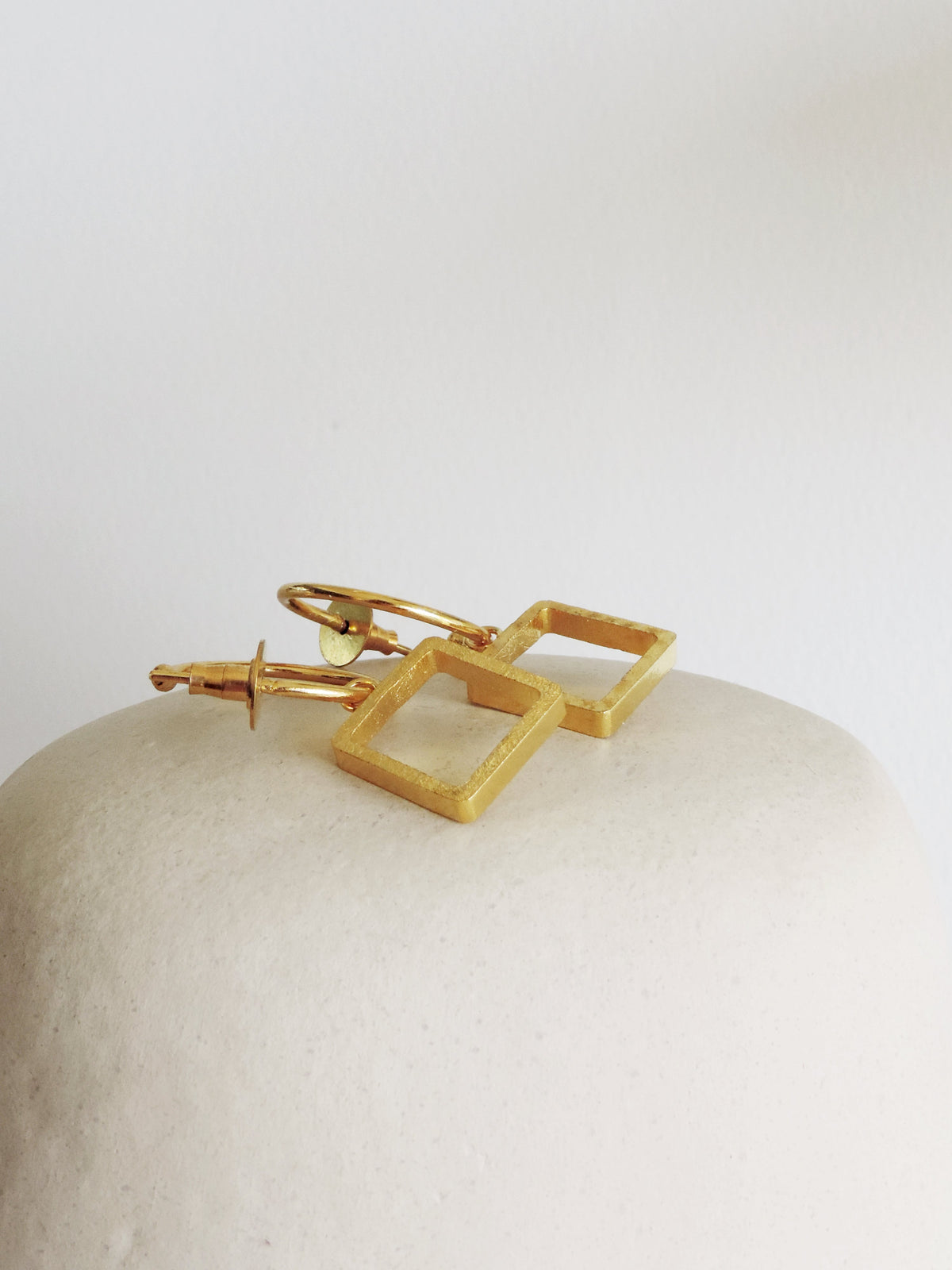 Oura Square XS De'anma brass geometric earrings worn model artisan India