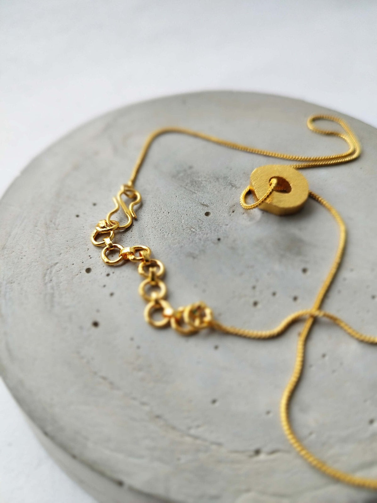 Gorria charm worn De'anma handcrafted brass charm necklace artisan India