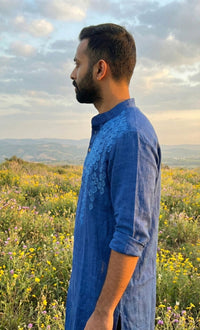 Man wearing a khadi cotton kurta with a relaxed fit and natural textured fabric.