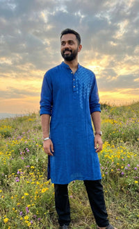 Man wearing a khadi cotton kurta with a relaxed fit and natural textured fabric.