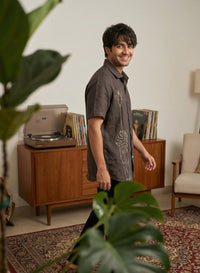 Linen shirt with hand embroidery, showcasing fine artisanal detailing on a soft, breathable fabric.