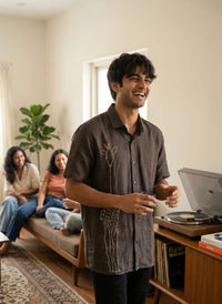 Linen shirt with hand embroidery, showcasing fine artisanal detailing on a soft, breathable fabric.