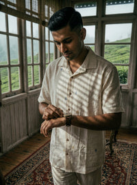 Off-white kala cotton shirt with delicate Jamdani weaving, showcasing fine textured motifs in a lightweight, breathable fabric.