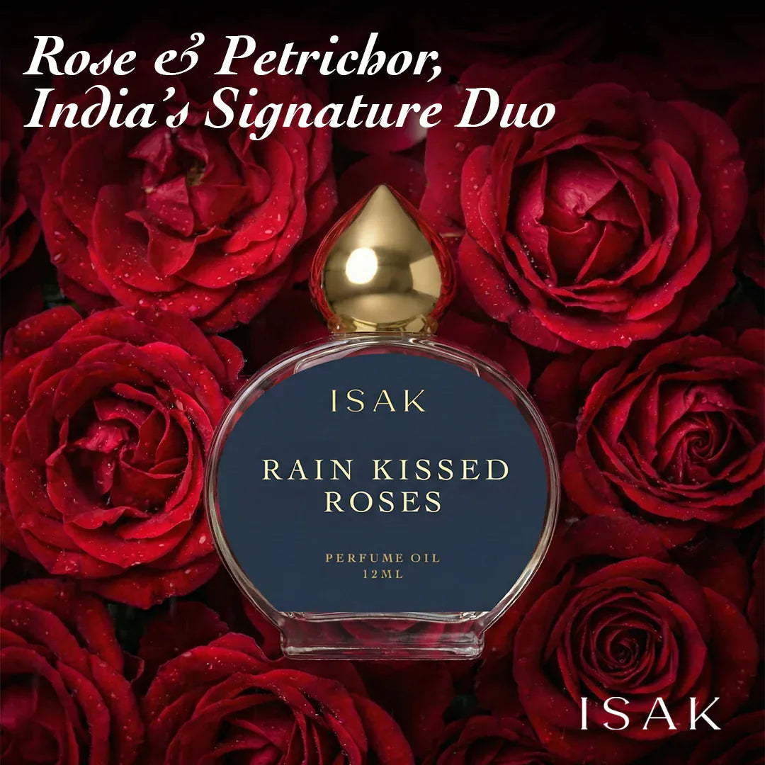 ISAK Rain Kissed Roses perfume oil bottle surrounded by red roses with text 'Rose & Petrichor, India's Signature Duo'.