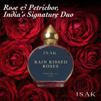 ISAK Rain Kissed Roses perfume oil bottle surrounded by red roses with text 'Rose & Petrichor, India's Signature Duo'.