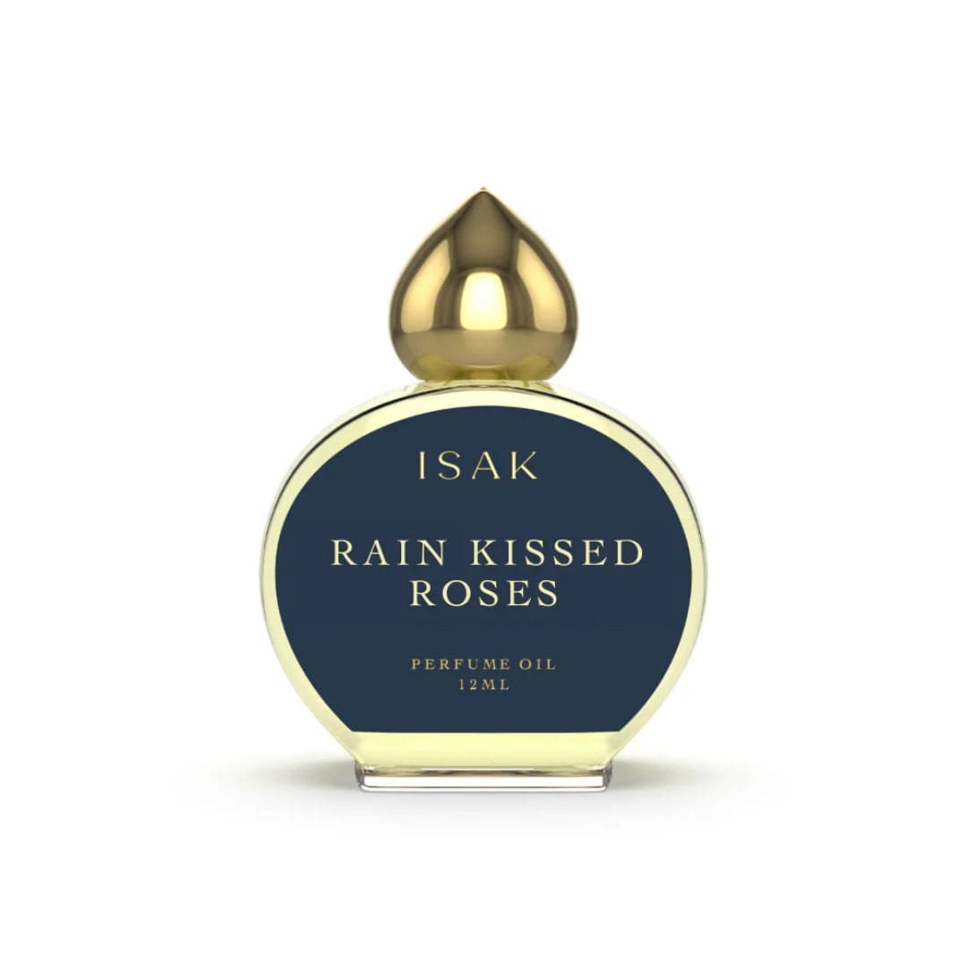 Perfume oil bottle labeled 'Rain Kissed Roses' by ISAK 