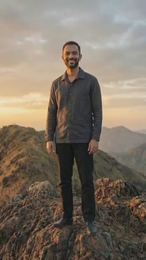 Handwoven kala cotton shirt designed with subtle embroidery, offering texture and everyday comfort.