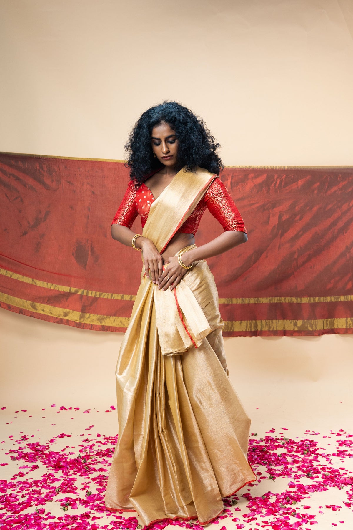 A luxurious rose gold handwoven tissue saree