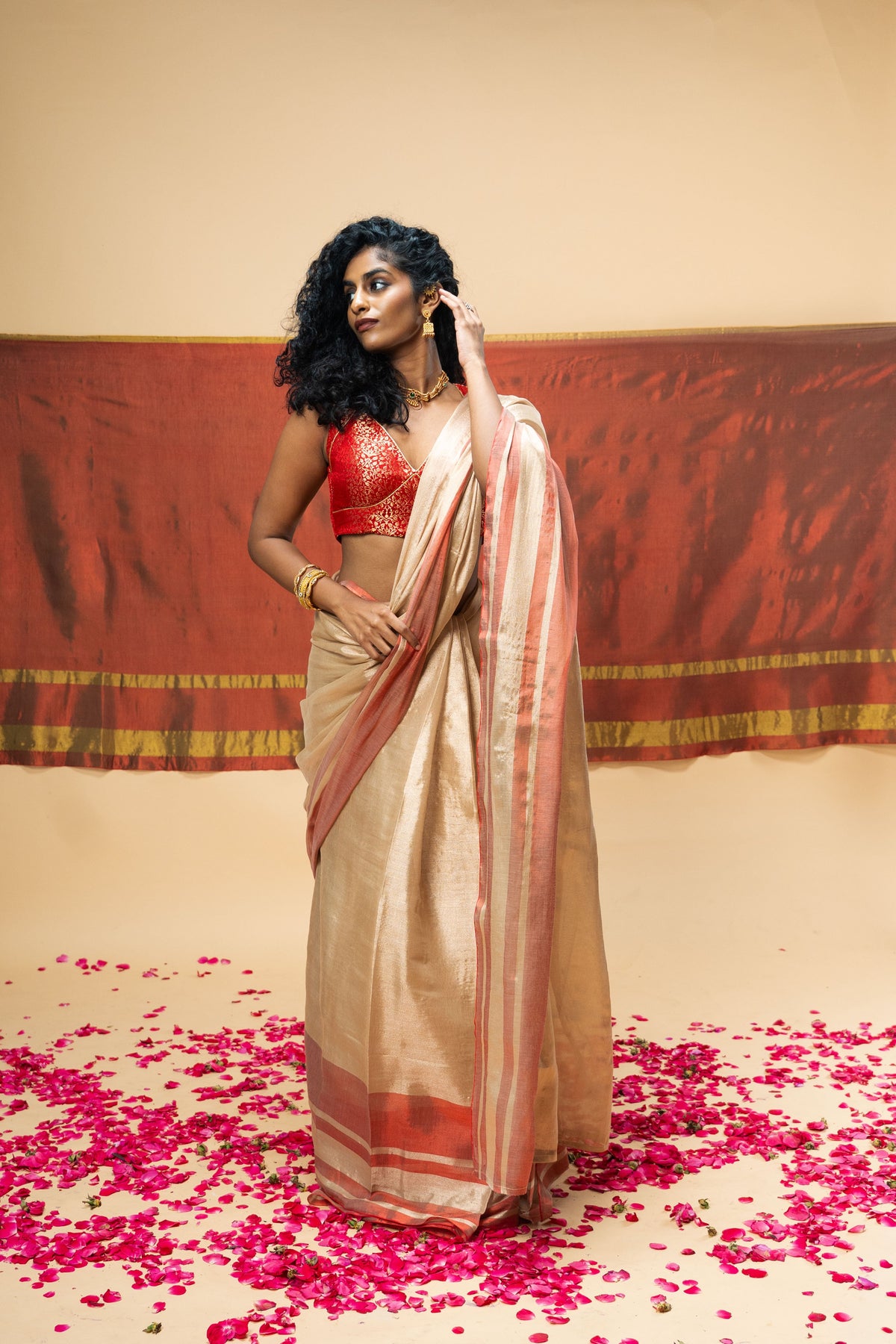 A luxurious rose gold handwoven tissue saree