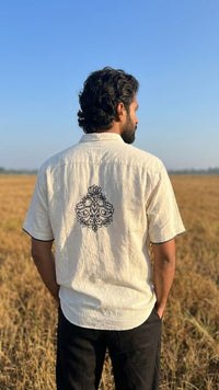 Man  wearing a white shirt with a design on the back.